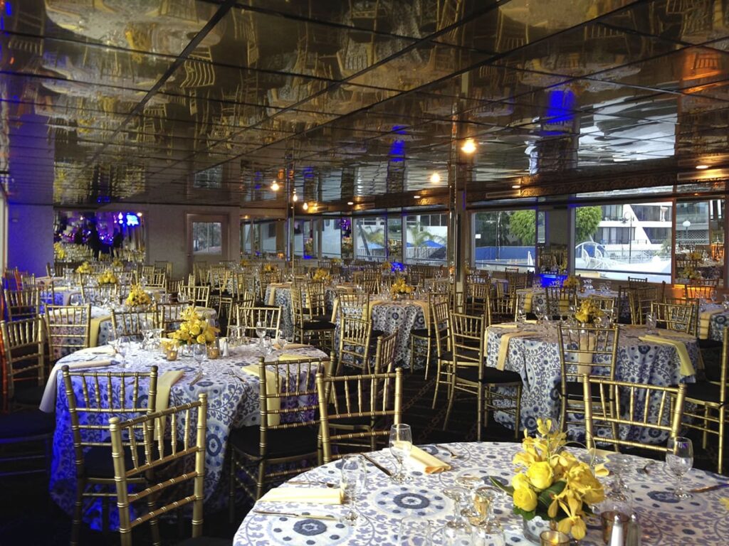 dining area with gilded seats and round table on a yacht for corporate networking event
