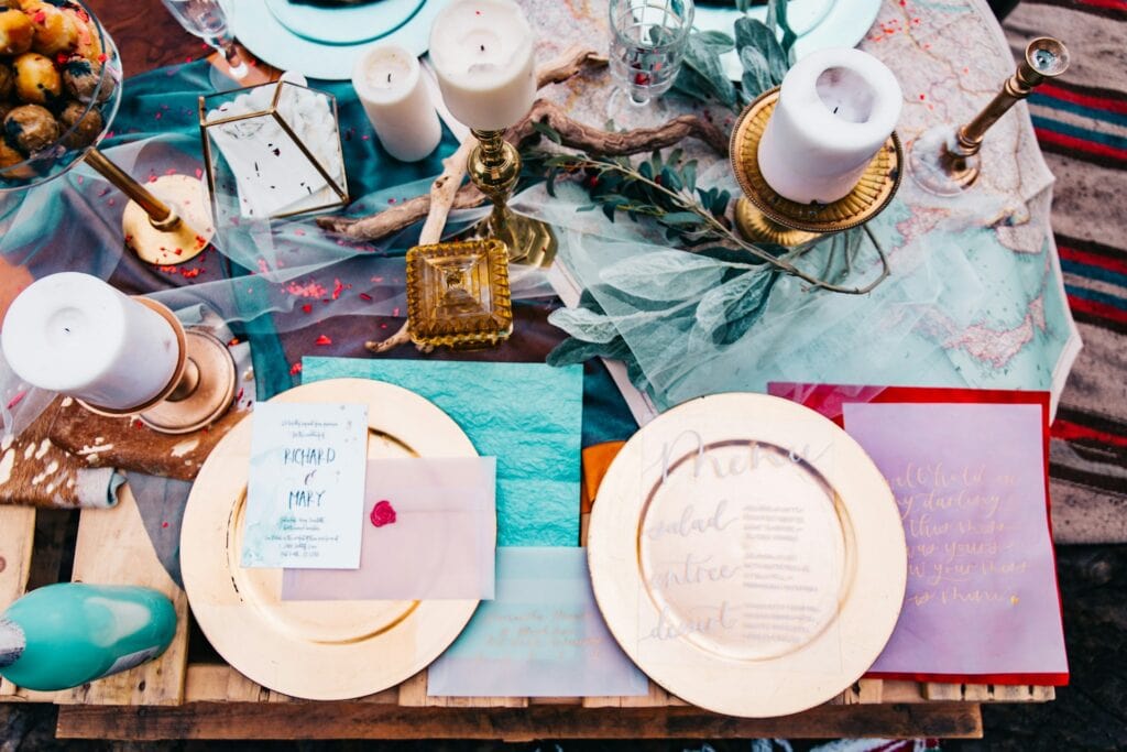 bridal placesetting, overhead shot, pinks and blues with gold charger