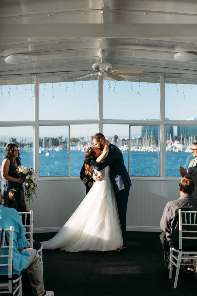 end of wedding ceremony with bride and groom kissing on a FantaSea yacht